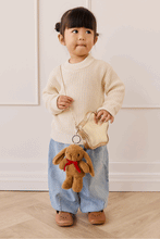 
                        
                          Load image into Gallery viewer, Snuggle Bunnies Penelope Keyring  in color Toffee  a hand holding golden bag
                        
                      