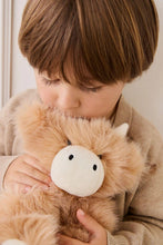 
                        
                          Load image into Gallery viewer, Child holding a plush toy resembling a cow
                        
                      