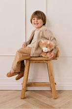 
                        
                          Load image into Gallery viewer, Child sitting on a wooden stool with a teddy bear, wearing a beige outfit against a white wall.
                        
                      