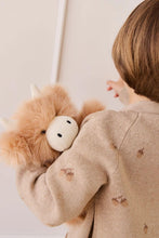 
                        
                          Load image into Gallery viewer, Child wearing a beige coat with a fluffy toy on their back against a plain background
                        
                      