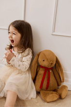 
                        
                          Load image into Gallery viewer, Snuggle Bunnies Penelope - Toffee - 45 cm laughing toddler sitting with bunny 
                        
                      