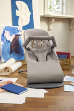 
                        
                          Load image into Gallery viewer, Gray baby bouncer with teddy bear designs on a wooden floor.
                        
                      