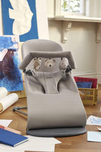 
                        
                          Load image into Gallery viewer, Gray baby bouncer with teddy bear designs on a wooden floor.
                        
                      