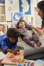 
                        
                          Load image into Gallery viewer, Child on the wooden floor with a baby, both engaged in activities, with a mum nearby
                        
                      