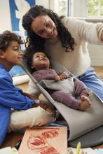
                        
                          Load image into Gallery viewer, Mum with two children in a home setting, one child in a baby bouncer.
                        
                      