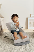 
                        
                          Load image into Gallery viewer, toddler sitting on a gray baby bouncer in a room with a neutral color palette.
                        
                      