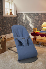 
                        
                          Load image into Gallery viewer, Blue baby bouncer in a room with a window and lamp.
                        
                      