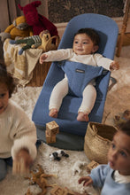 
                        
                          Load image into Gallery viewer, Baby in a blue baby bouncer surrounded by toys and children in a home setting
                        
                      
