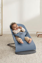 
                        
                          Load image into Gallery viewer, Baby in a blue baby bouncer with a neutral background
                        
                      