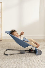 
                        
                          Load image into Gallery viewer, baby in a blue baby bouncer on a carpeted floor with a white wall background
                        
                      