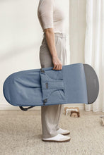 
                        
                          Load image into Gallery viewer, Person holding a blue baby bouncer in a neutral indoor setting
                        
                      
