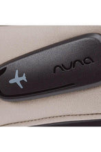
                        
                          Load image into Gallery viewer, Nuna suitcase handle with airplane icon on beige background
                        
                      