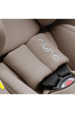 
                        
                          Load image into Gallery viewer, Nuna car seat with visible brand logo on a beige background
                        
                      